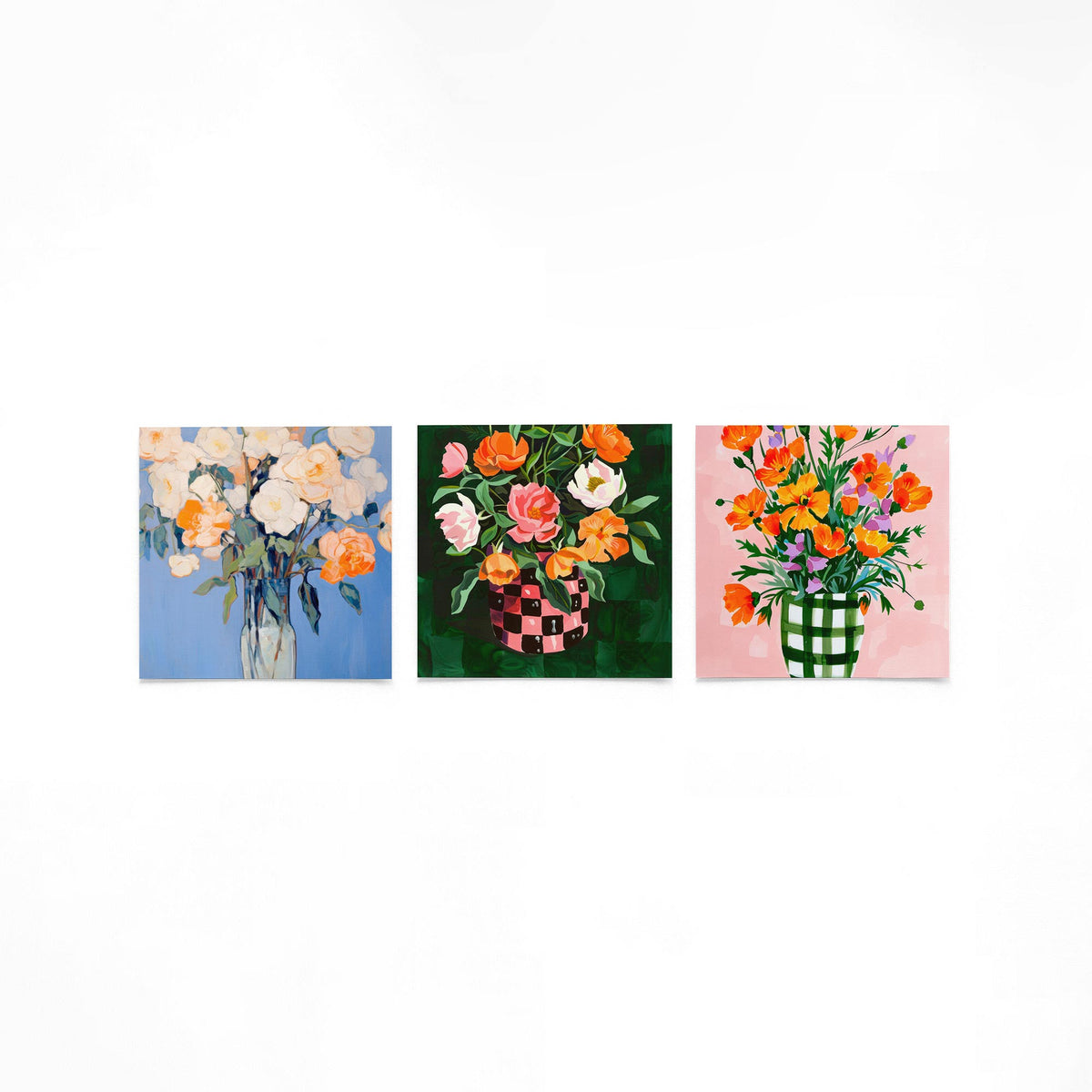 Drie vierkante posters met kleurrijke bloemenvazen op een gebroken witte achtergrond