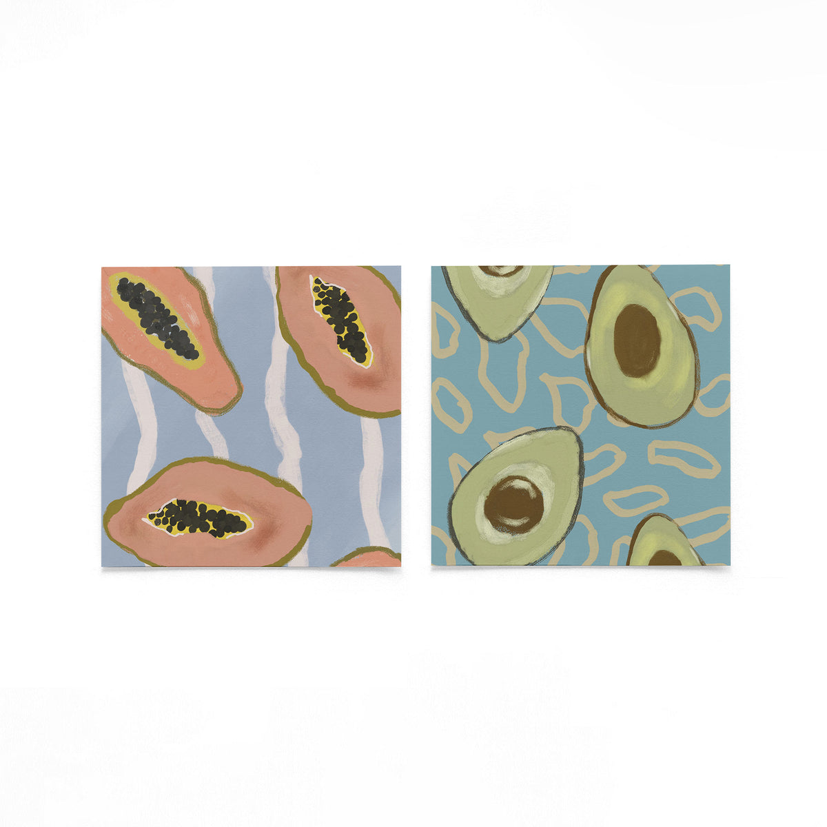 Twee vierkante posters met papaja en avocado op een gebroken witte achtergrond