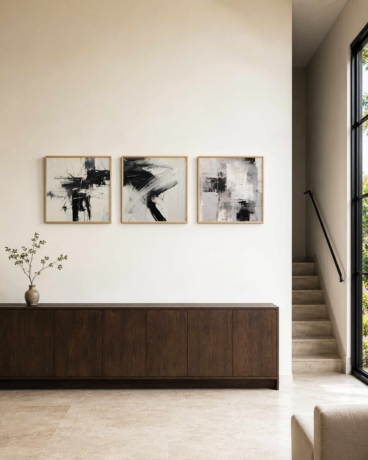 Interieurpresentatie van een driedelige vierkante posterset met abstracte zwart wit